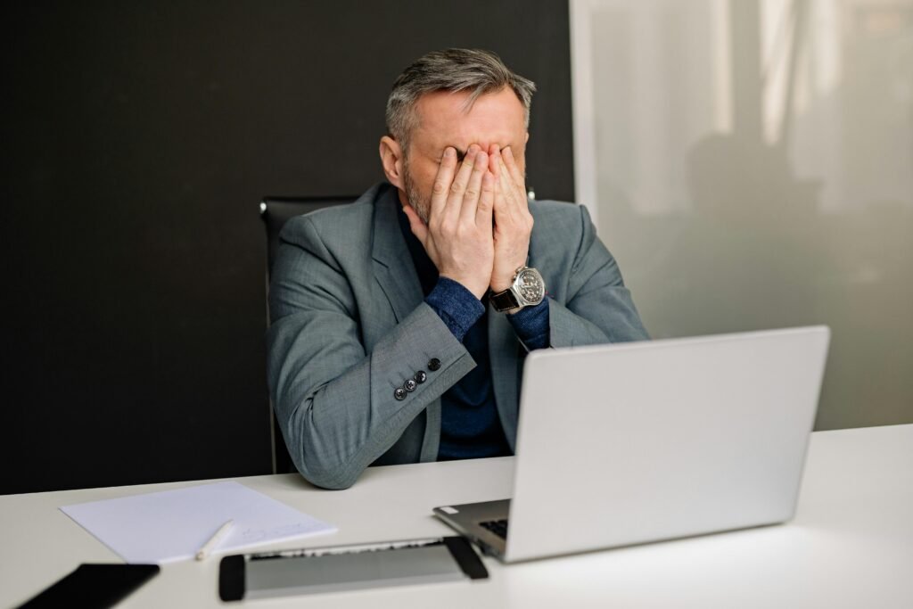pexels-photo-7793987-7793987 Businessman in gray suit showing frustration while working in office.